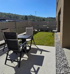 a patio with a table and a chair on a patio at Sunlit Oasis Garden in Postojna