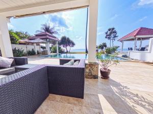 an outdoor patio with purple furniture and a swimming pool at Beachfront! 4 Bedrooms - Malee Beach Villa E6 in Phra Ae beach