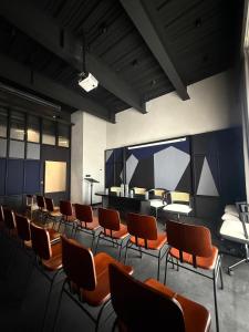 a room with chairs and a table and a piano at Terratone Boutique Business Hotel in Kollam