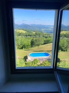 a window with a view of a swimming pool at Villa Doubledot in Piane di Montorio