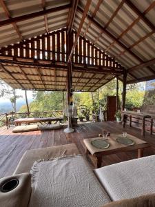 a large wooden patio with a table and a couch at Sunset Sea View House Large Terrace 2BR in Ban Nok