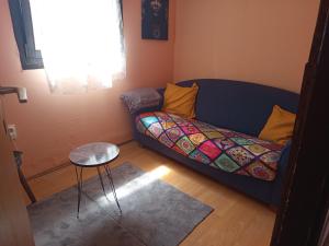 a living room with a couch and a table at Kucica za odmor Lena I Matija in Sremski Karlovci