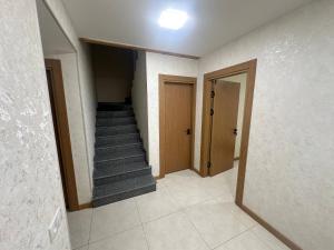 an empty hallway with a staircase and a door at Olchazor hotel in Tashkent