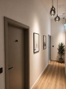 a hallway with a door and pictures on the wall at Berlin Sleep Club in Berlin