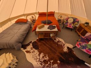 a room with a bed and a table in a tent at Private Luxury Glamping surrounded by wildlife in Pembrokeshire