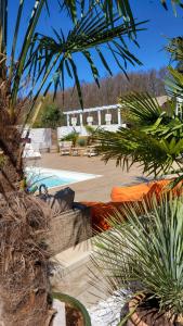 a resort with a pool and some palm trees at Kopań Kabana in Darłowo
