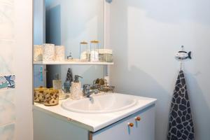 a bathroom with a sink and a mirror at La Rose des Mers in Tréffiagat +59 photos
