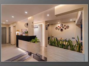 a lobby with plants in pots in a building at Aywa Hotels Edapally in Cochin