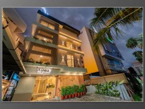 a tall building with a sign in front of it at Aywa Hotels Edapally in Cochin