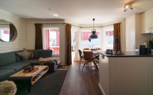 a living room with a couch and a table at Central Ski-In Ski-Out Apartment in Vemdalen