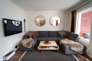 a living room with a couch and a table at Central Ski-In Ski-Out Apartment in Vemdalen