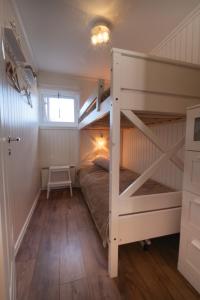 a bedroom with a bunk bed with a ladder at Central Ski-In Ski-Out Apartment in Vemdalen