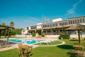a resort with a swimming pool and a building at Bungalows Papalus - Golf Lloret - in Lloret de Mar