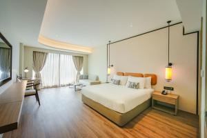 a hotel room with a bed and a living room at ACASA Collective in Aurangabad +117 photos