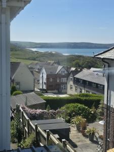 a view of a town with houses and the water at Downside Annexe in Woolacombe