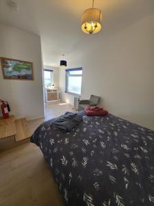 a bedroom with a bed with a black comforter at Downside Annexe in Woolacombe
