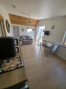 a living room with a table and a couch at Downside Annexe in Woolacombe