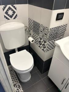 a bathroom with a white toilet and a sink at Villa Doubledot in Piane di Montorio