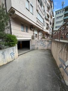 an empty parking lot in front of a building at Nina Center Apartment in Skopje
