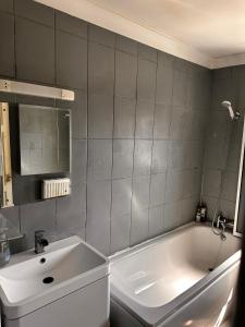 a bathroom with a white tub and a sink at 5 Bedroom house Doncaster in Balby +12 photos