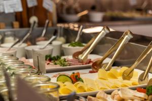 a buffet line with plates of food on display at Hotel Alter Muschelsaal in Büsum