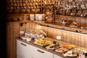 a buffet with many plates of food on a counter at Hotel Alter Muschelsaal in Büsum +22 photos