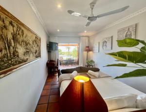 a bedroom with two beds and a living room at Goblin's Inn in St. Helena Bay