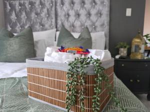 a bedroom with a bed with a basket of food at Grey Crescent living in Welkom
