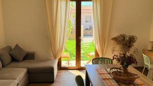 a living room with a couch and a table at Su Entu Suite Free Parking 5 min from the sea in Giba