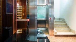 an elevator in a building with a staircase and a stair at Suiteincenter Rooms in Palermo