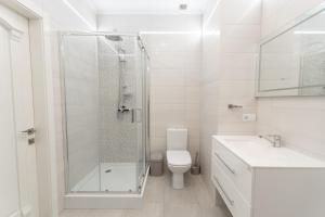 a bathroom with a shower and a toilet and a sink at Galaktyka Hotel in Stantsiya Biskovitse +37 photos