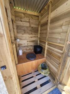 an inside of a wooden sauna with a toilet at Private Luxury Glamping surrounded by wildlife in Pembrokeshire +13 photos