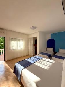 a large bedroom with two beds and a window at Hotel Bar Restaurant MANI in Velipojë