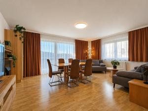 a large living room with a table and chairs at Seehaus Gori in Maria Wörth