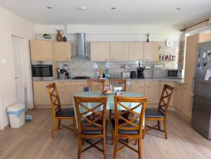 a kitchen with a table and chairs and a refrigerator at Balaton House in Balatonboglár