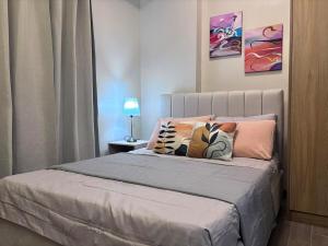 a bed with pillows on it in a bedroom at Polished Studio at The Verdin Maple Grove in General Trias +6 photos