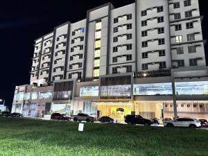 a large building with cars parked in front of it at Polished Studio at The Verdin Maple Grove in General Trias