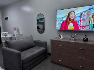 a living room with a flat screen tv on a dresser at Polished Studio at The Verdin Maple Grove in General Trias