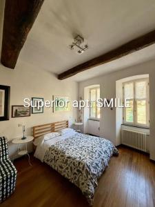 a bedroom with a bed and a table and two windows at La Scala Vernazza CinqueTerre in Vernazza