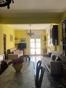 a living room with a table and a couch at VILLA FELICE in Loano