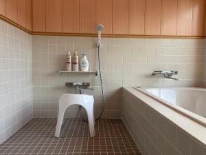 a bathroom with a white sink and a bath tub at 近露の家 -chikatsuyunoie- in Tanabe +62 photos