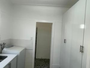 a white bathroom with a sink and a toilet at Easy Wagga Stopover, Spacious & Comfortable in Forest Hill +14 photos