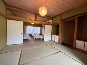 a room with a bedroom with a bed and a lamp at 近露の家 -chikatsuyunoie- in Tanabe