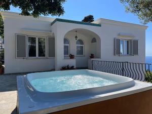 a hot tub in front of a house at Villa Claudia in Anacapri