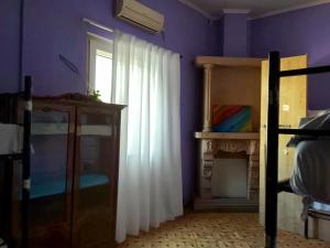 a bedroom with a bed and a window and a fireplace at Colors Hostel in Tbilisi City +34 photos