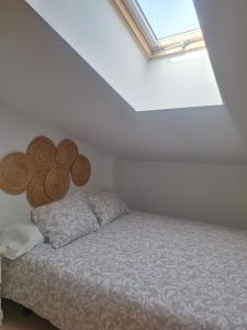 a bed in a white room with a window at Aromas del Jiloca in Calamocha