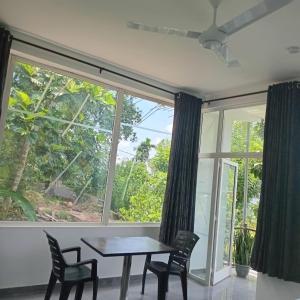 a dining room with a table and chairs and a large window at Kandy Fortress in Kandy +48 photos