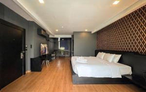a bedroom with a large white bed in a room at G Boutique Silom Hotel in Bangkok +16 photos