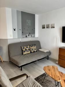 a living room with a couch and a table at Apartament Patio 50 m od plaży in Władysławowo