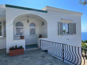 a white house with a black fence at Villa Claudia in Anacapri +21 photos